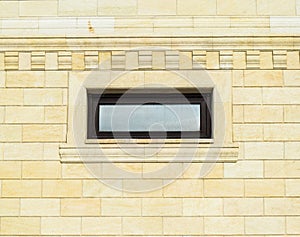 Background of yellow brick and windows. Wall of yellow bricks with a plastic window. The texture of the wall