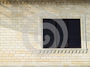 Background of yellow brick and windows. Wall of yellow bricks with a plastic window. The texture of the wall