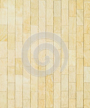 Background of yellow . Wall of yellow bricks. The texture of the wall