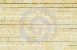 Background of yellow bricks. Wall of yellow bricks. The texture
