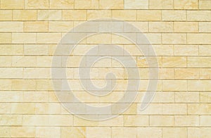 Background of yellow bricks. Wall of yellow bricks. The texture of the wall.