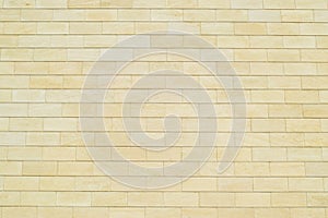 Background of yellow bricks. Wall of yellow bricks. The texture of the wall.