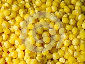 Background of yellow millet grains, direct down view. Macro photography