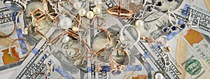 Backgrounds of American dollars and jewelry. Flat lay, top view.