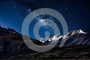 Backgrounds night sky with stars and milky way over the snow- capped mountains at south island