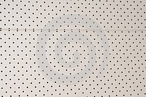 Backgrounds and textures from leather in white with a perforation