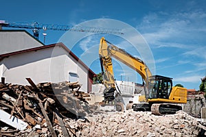 Backhoe demolishing a house