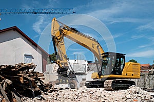 Backhoe in the demolition of a house