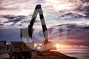 Backhoe or digger working at earth excavation site