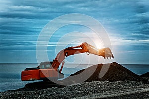 Backhoe or digger working at earth excavation site