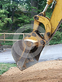 Backhoe digging dirt