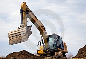 backhoe digging hydraulic shovel on construction site earth mover excavator dumping earth