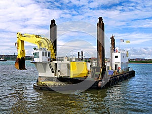 Backhoe Dredger Beginning Dredging Operations.