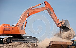 Backhoe Dumping Dirt photo