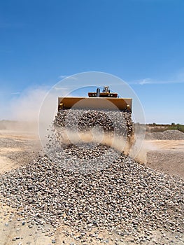 Backhoe Dumping Gravel