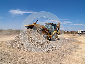 Backhoe Dumping Gravel photo