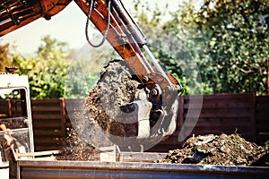 Backhoe excavator moving earth on construction site