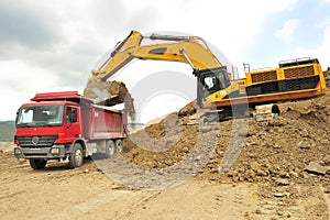 Backhoe loader loading truck