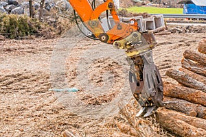 Backhoe log grapple attachment