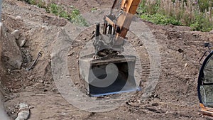 Backhoe in motion and is ready to get some soil