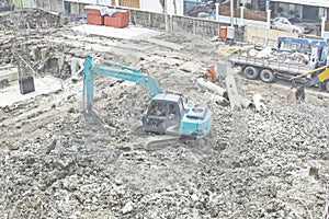 Backhoe penetrate the concrete construction.