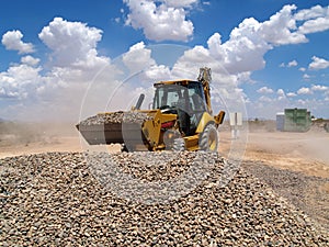 Backhoe Shoveling Gravel