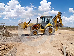 Backhoe Shoveling Gravel