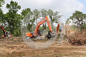 Backhoes Clearing Land
