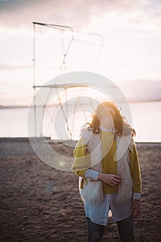 Backlight portrait of young female tilting her head up at sunset