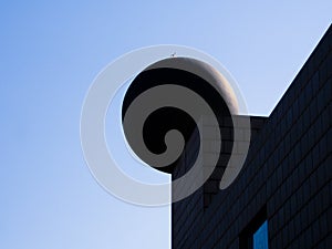 Backlighted concrete sphere in building