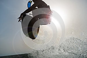 Backlighting of a Surfer jumping at sunset