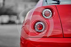 The backlights of an red Italian sport car from the 90s