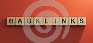 Backlinks - conceptual text with wooden cubes.3D rendering on red background