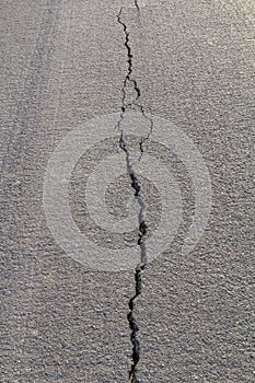 Backlit asphalt cracks