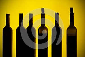 Backlit bottles behind a bar