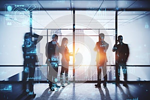Backlit business people working tohether in abstract creative blurry office interior with business charts and binary code. System