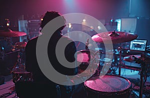 Silhouette of a Drummer Performing on Stage