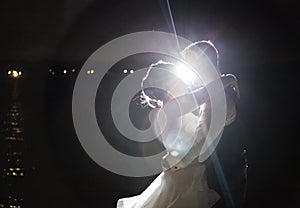 Backlit night wedding couple kissing