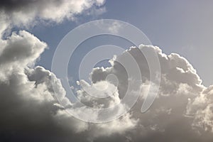 Backlit nimbus clouds with patch of blue sky