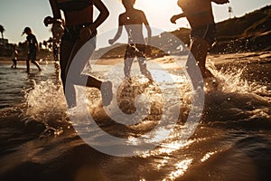 Backlit shot of teenagers running, having fun, playing and splashing water around them. At the beach during a sunny afternoon