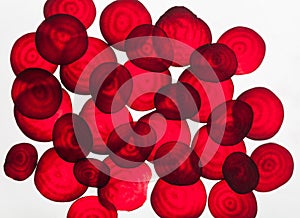 Backlit slices of beetroot, abstract textured background