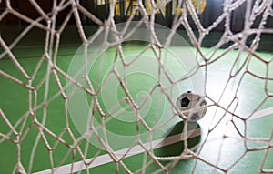 Backlit soccer ball in a goalpost