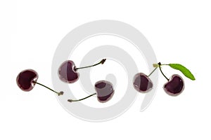 Backlit stella cherries with water drops isolated on white background