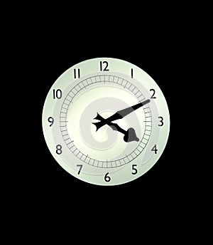 Backlit white clock on a wall wtih black background