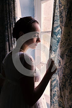 Backlit woman in regency dress