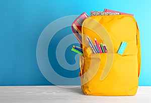 Backpack with different colorful stationery photo