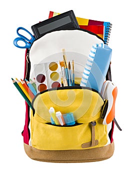 Backpack isolated on white backgorund with protruding school supplies photo