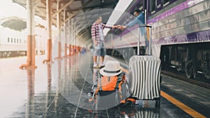 Backpack, luggage and hat over travellers at train station. Travel concept