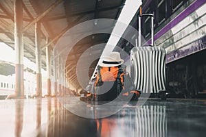 Backpack, luggage and hat at train station. Travel concept