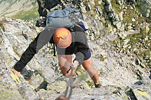 Backpack man climbing